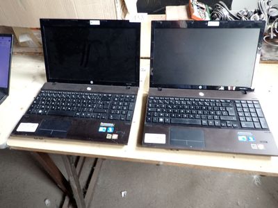 two laptops that are sitting on a table