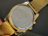 a person holding a watch in their hand on a table