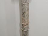 a marble pedestal in the corner of a room