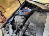 the engine of a car with a bunch of batteries in it
