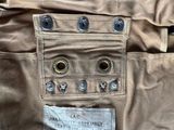 a label on the pocket of a tan pants