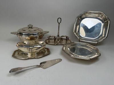 several pieces of silverware are arranged on a white surface