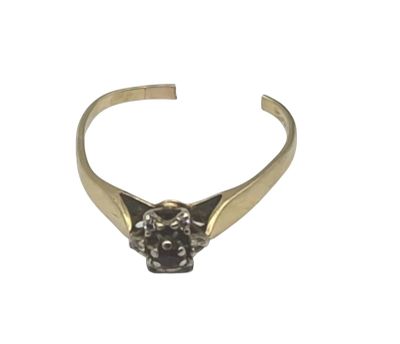 a close up of a gold ring with a black diamond on it