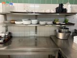 a stainless steel counter top in a kitchen with dishes on it