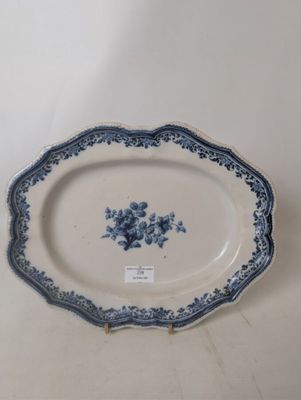 an antique blue and white platter with blue flowers on it