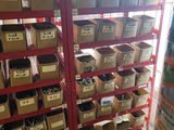 boxes of assorted items are stacked on a rack in a warehouse