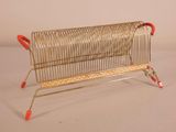 a small metal rack that has a red handle on it