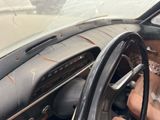 a woman that is sitting in the driver ' s seat of a car