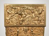a gold box with a design of a man and a woman on a horse