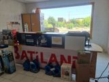 a counter that has a lot of boxes and a laptop on it