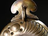 a close up of a metal object with a bird on it