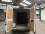 a white van with a wooden door open in a building