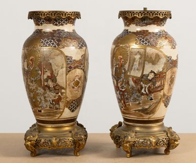 two vases are sitting on a table with a painting on them