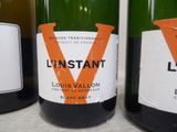 several bottles of wine are lined up on a table