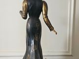 an image of a statue of a woman with a hat on her head