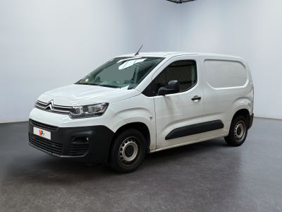 the white van is parked in a large white room