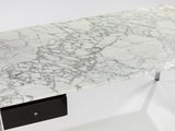 a marble table with a black drawer underneath it