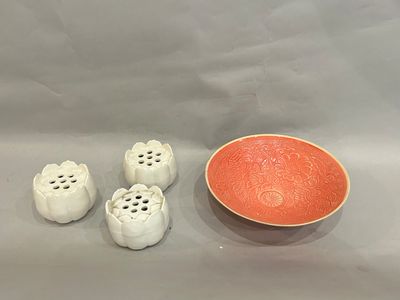 a bowl and four salt and pepper shakers next to a bowl
