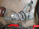 a corded drill and other tools laid out on the floor