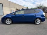 the blue toyota prius is parked in front of a building