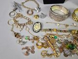 a lot of gold and silver jewelry sitting on a table