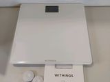 a white electronic scale sitting on top of a table