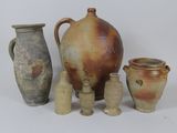 a group of vases sitting next to each other on a white surface