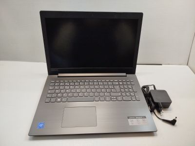 an open laptop computer sitting on top of a table next to a charger