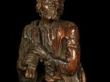 statue of an old man with a hat and a cane