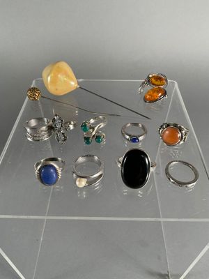 a clear display case with various rings and rings on it