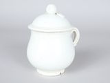 white porcelain teapot with a lid and a bird on the top