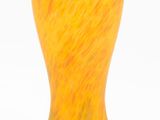 an orange vase sitting on a white surface with a white background