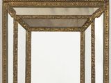 un miroir au cadre doré ouvragé accroché au mur, à côté d'un mur blanc