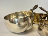 two bowls and a spoon sitting next to each other on a table