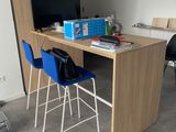 a desk with two chairs and a computer on top of it