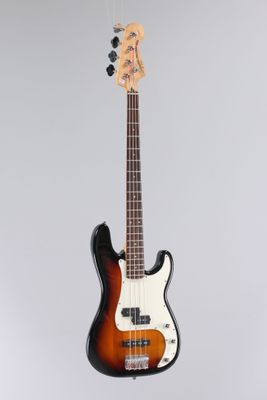 a close up of a bass guitar hanging from a string