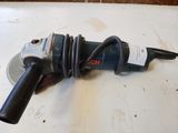a close up of a drill on a table with a cord