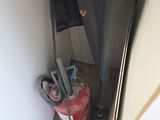 a red fire hydrant in the corner of a room