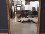 a mirror that is sitting on the floor in a room