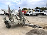 vehicles parked in a parking lot with a tow truck attached to it