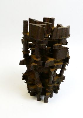 a sculpture made out of pieces of wood on a white surface