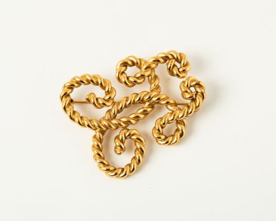 a close up of a gold necklace on a white surface