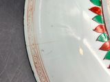 a white plate with a red and green design on it