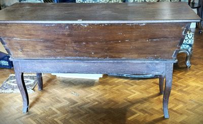 a wooden table with a wooden top on a hard wood floor