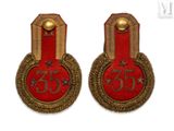 pair of red and gold badges with the number 35 on them