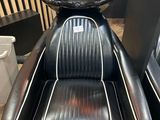 a black barber chair with a tray on top of it