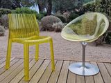 a yellow chair and a yellow chair sitting on a wooden deck