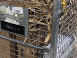 a metal cage with a bunch of cardboards inside of it
