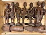 a lot of wooden statues that are on a shelf