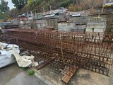 a large pile of steel bars on the side of the road